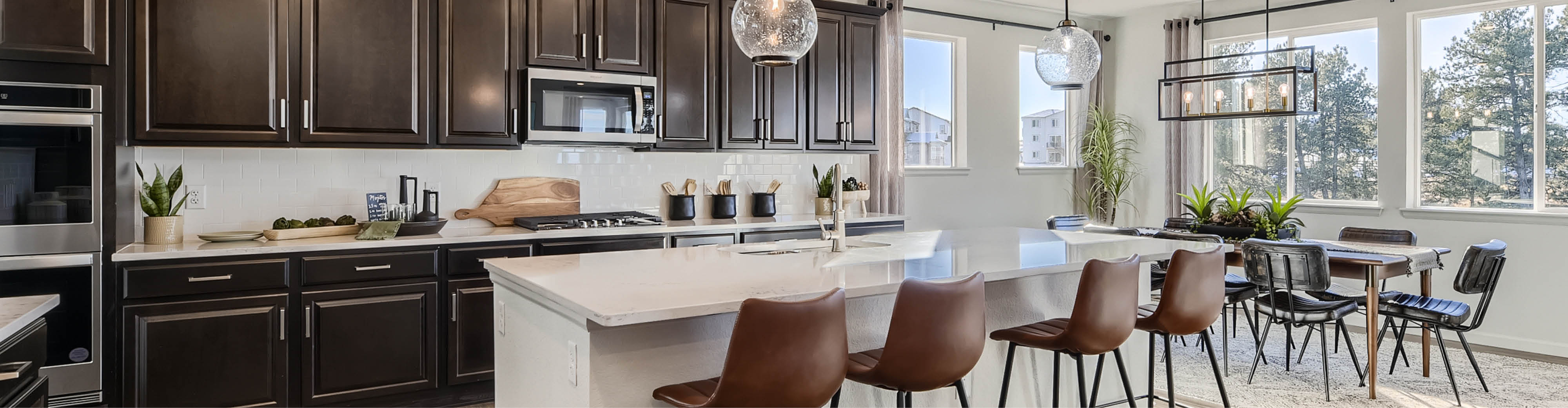 A kitchen with a table and chairs.