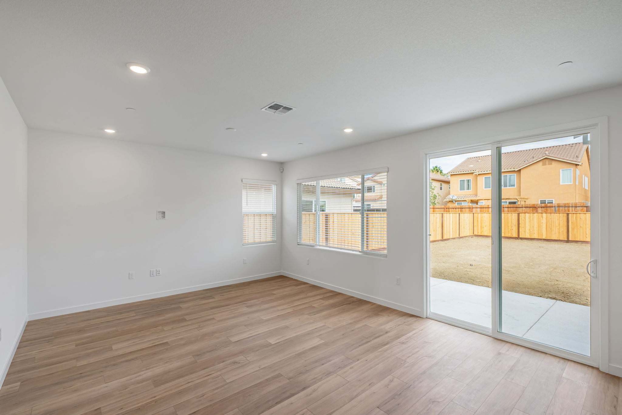 A room with a wood floor and a wood floor with a wood railing.